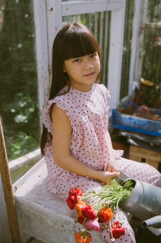 Pink polka dot kids blouse in organic cotton with frill details and button back by Little Harper Lee